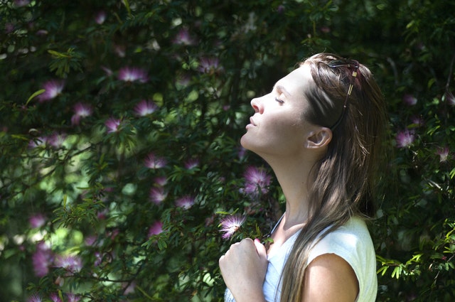 Woman enjoying sunbeams on her face.